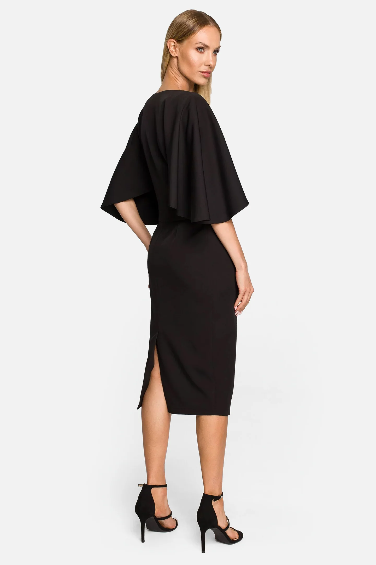 Model wearing a black dress with wide sleeves